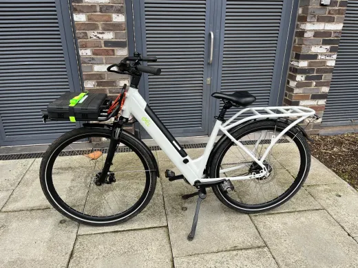 Tradesperson's toolbox carried on the front rack of a CYCL e-bike on a London street